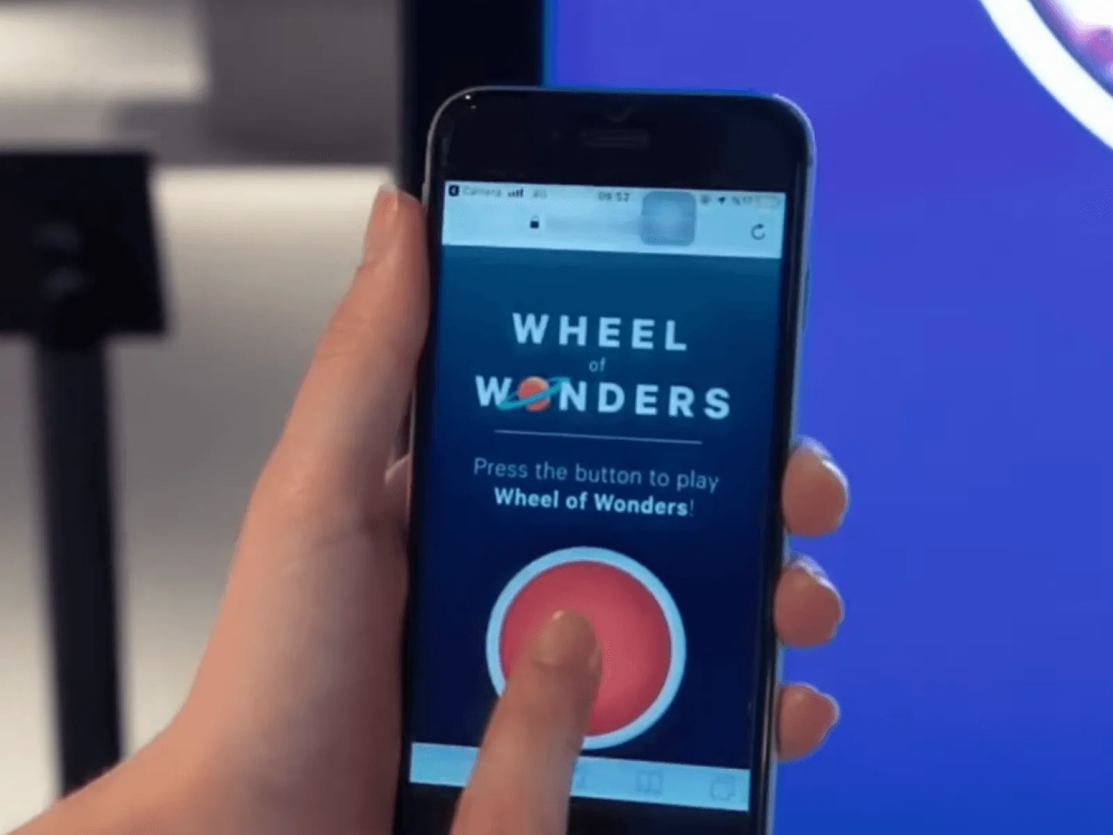 The 'Wheel of Wonders' game open on a customer's phone, ready to play