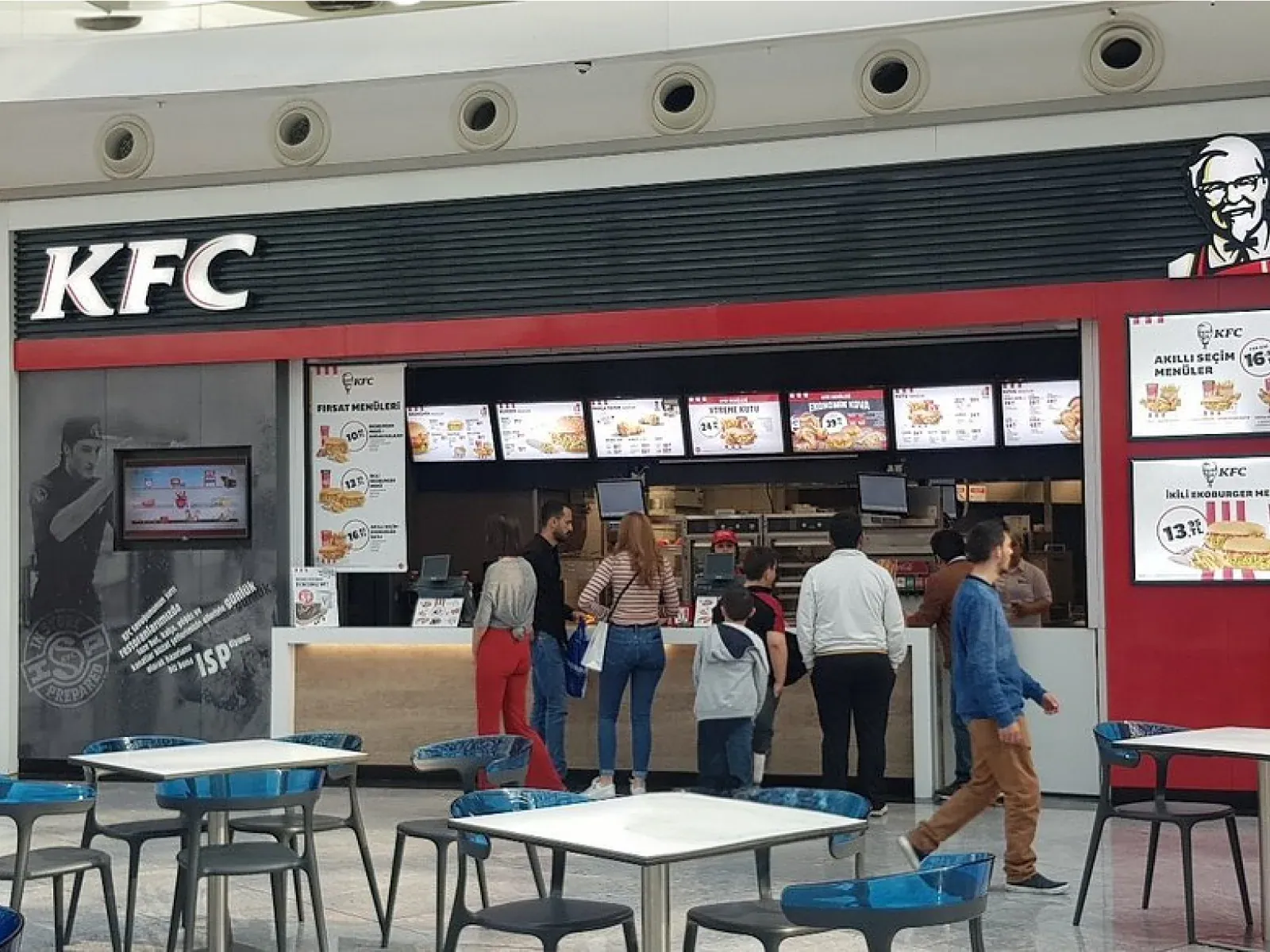 KFC menu screens showing segmented pricing above the counter