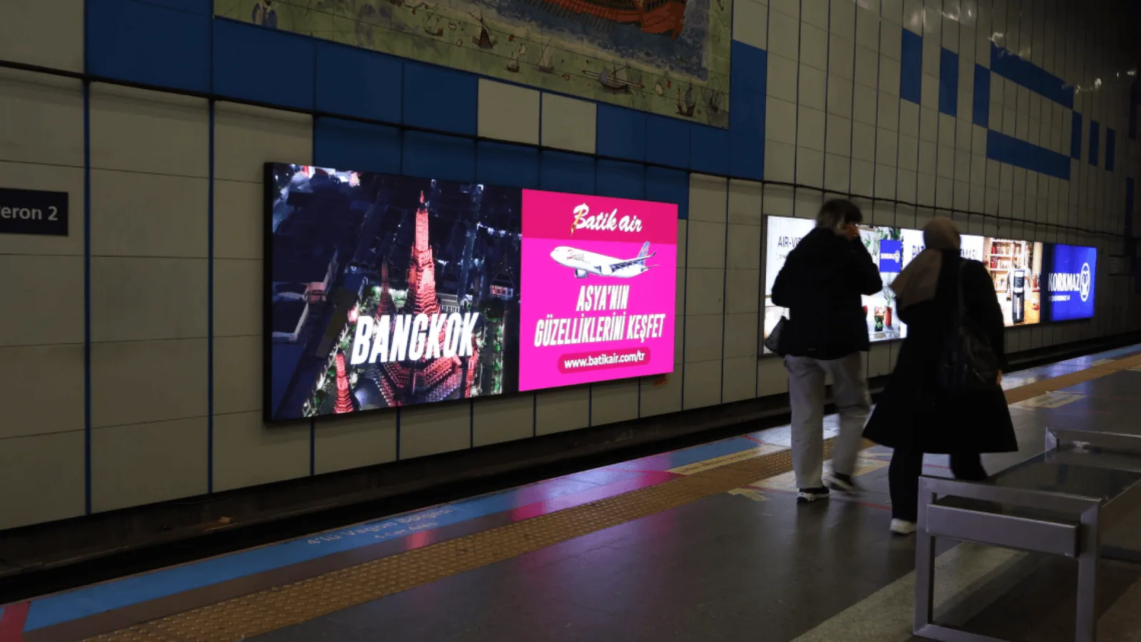 Public-space screens running rotating digital-out-of-home campaigns