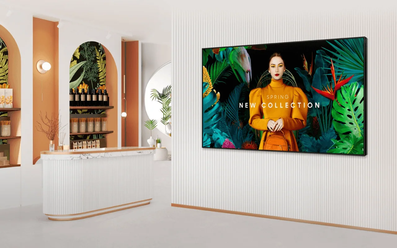 A wall-mounted Samsung Smart Signage display showing a fashion campaign in a retail store